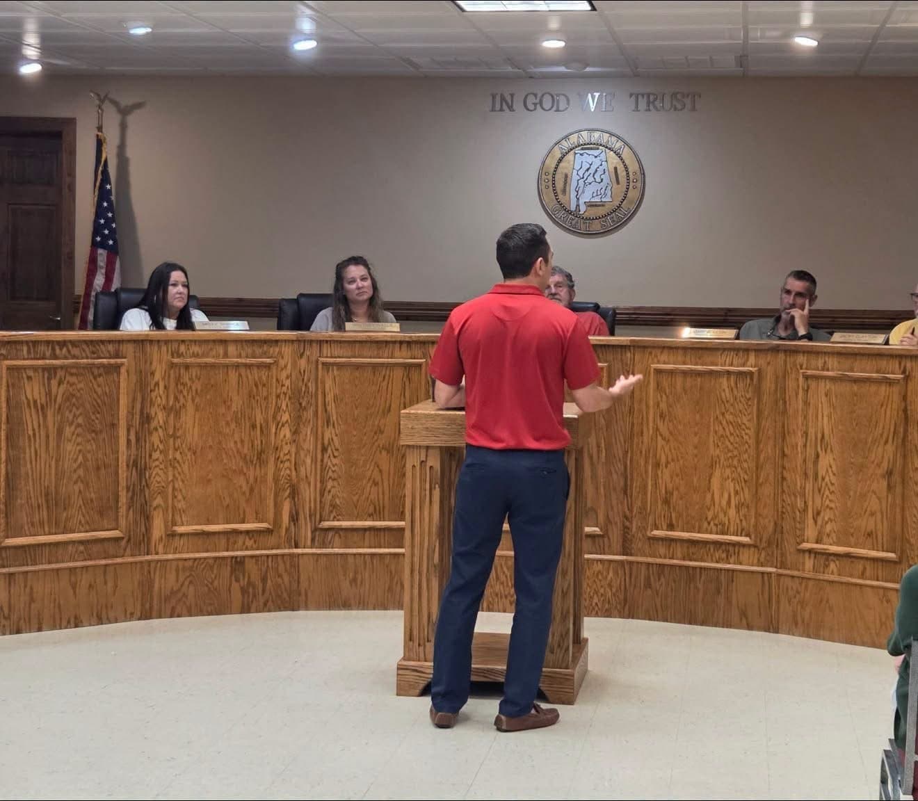 Jesse speaking to a city council from the podium